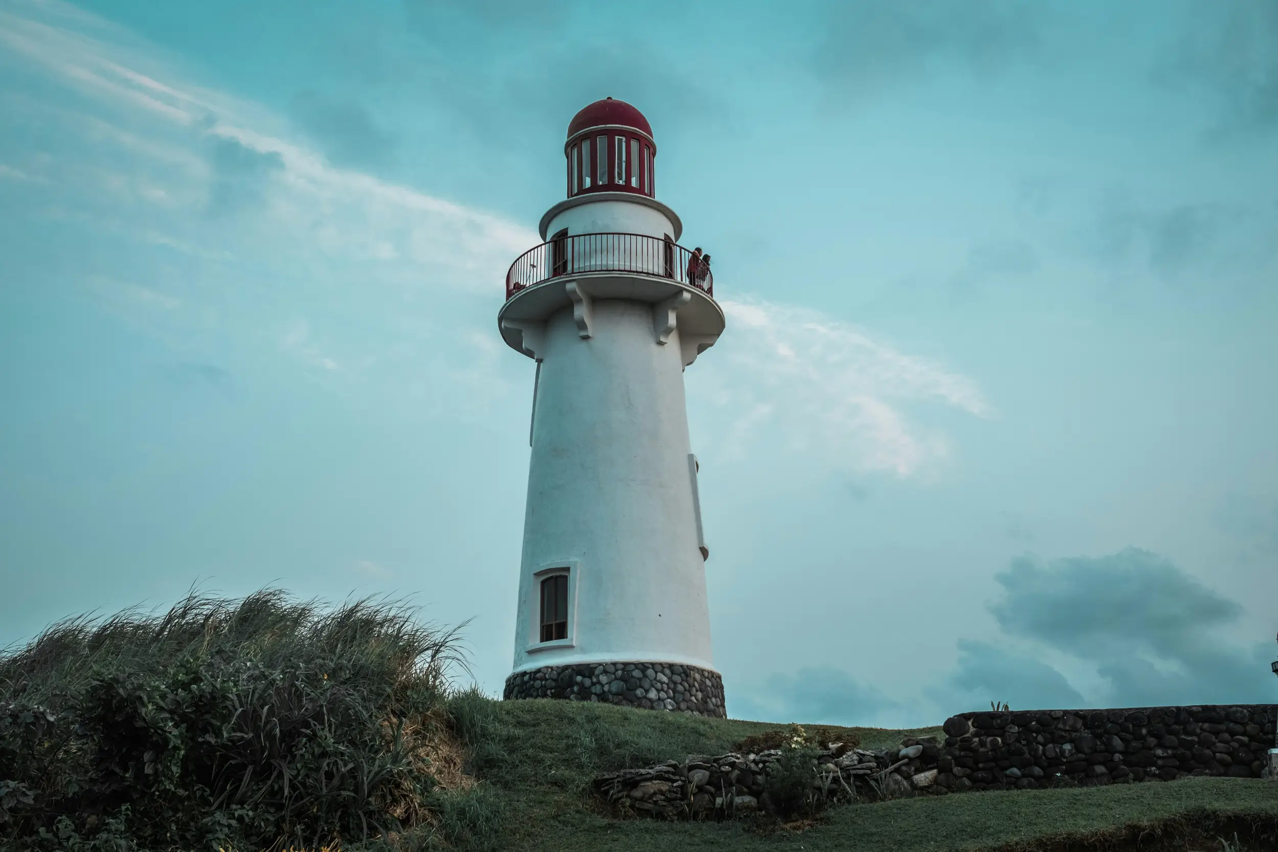 Basco Lighthouse standing tall on a grassy hill in Batanes, Philippines